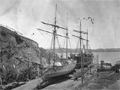 Two old sailing ships on slipway