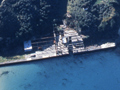 View down on wharf structure next to small beach