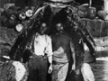 Two men pose inside the mouth of a dead whale