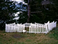 White-picket fence with information sign in front