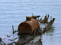 Rusty metal boiler on remains of beached vessel