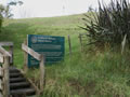 Sign for Te Whero's Redoubt next to wooden stiles