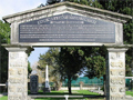 Gateway in front of cemetery with plaque proclaiming 'Maori War and Early Settlers Cemetery Rangiriri