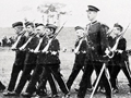 Cadets marching with crowd in background