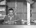 Māori carver at his post