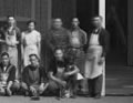 group standing outside carved house