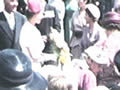 Queen talking to crowd from platform