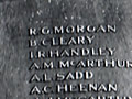 Roll of Honour mounted on wooden supports. The inscription and list of names are under a Kiribati flag. 
