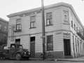 Thistle Inn with old truck and bicycle parked on road in front