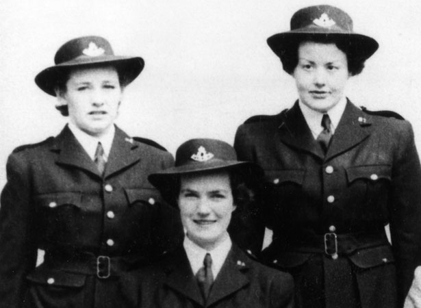 Three uniformed policewomen in group photograph