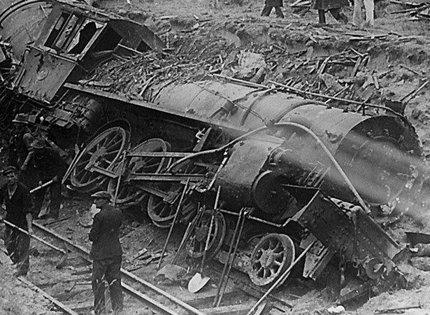 Onlookers view the crumpled carriages near Hyde