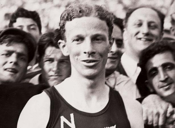 Jack Lovelock wearing a New Zealand running singlet in a crowd