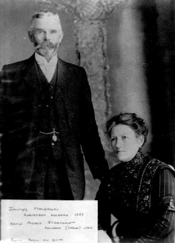 Man standing next to woman sitting on chair