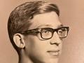 Young man with thick glasses in three-quarter profile
