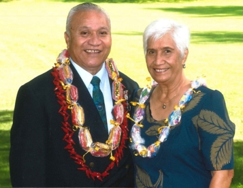 Elderly couple in formal clothes with lei around necks