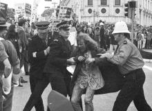 Police leading away an anti-Vietnam War protester, 1971