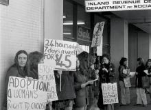 Women demonstrate outside a Social Welfare office, 1977