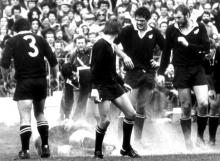 All Black prop Gary Knight is felled by a flour bomb