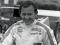 A smiling Bruce McLaren in his racing overalls