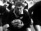 Colin Meads crouched with rugby ball in hand