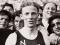 Jack Lovelock wearing a New Zealand running singlet in a crowd