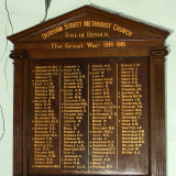 Wooden roll of honour hung on wall