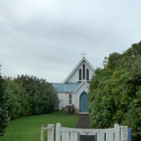 Wooden gate and path leading to wooden Church building 