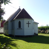 Small wooden church on well kept lawn