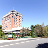 Multi-story library building with bus stop and road in front
