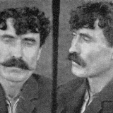 Mugshots of man with dark hair and moustache