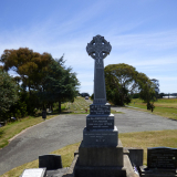 Front view of gravestone with Celtic cross at the top