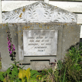 Plaque with writing inlaid at the bottom of a church building