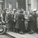 Queues of immigrants in London