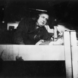 man in bunk listening to radio
