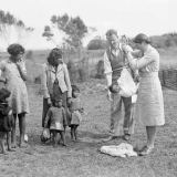 District nurse weighing baby, Waihara
