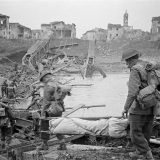 NZ soldiers crossing destroyed Italian bridge