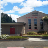 View of building with flagpole and flag outside