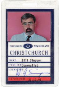 Identification card featuring text and picture of a bearded man with glasses in shirt and tie