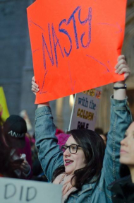 Women holding up 'Nasty' sign