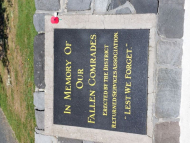 Black plaque set into ground with gold writing
