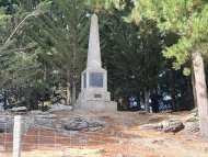 Memorial obelisk set among pine trees