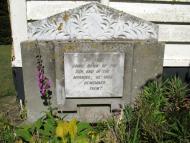 Plaque with writing inlaid at the bottom of a church building