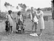 District nurse weighing baby, Waihara