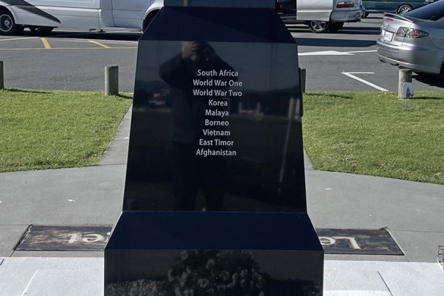 View of panel on black granite obelisk with list of military engagements on it