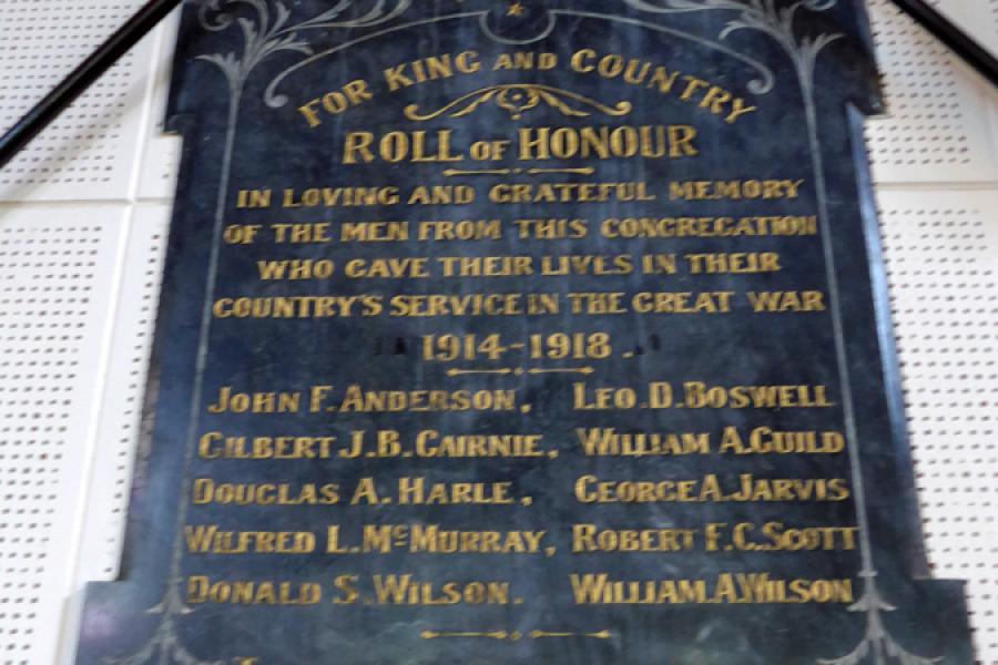Wooden board on wall with names in gold lettering
