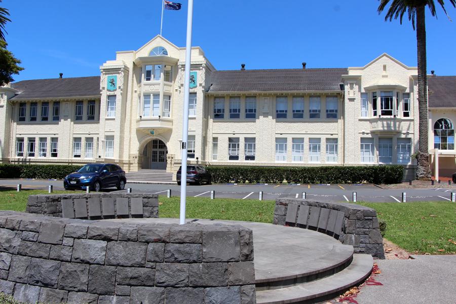White flagpole in front of art deco building 