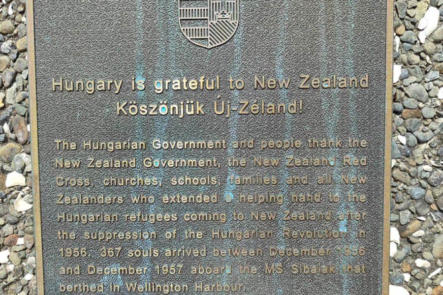 Commemorative plaque with Hungarian emblem above Hungarian and English lines of text