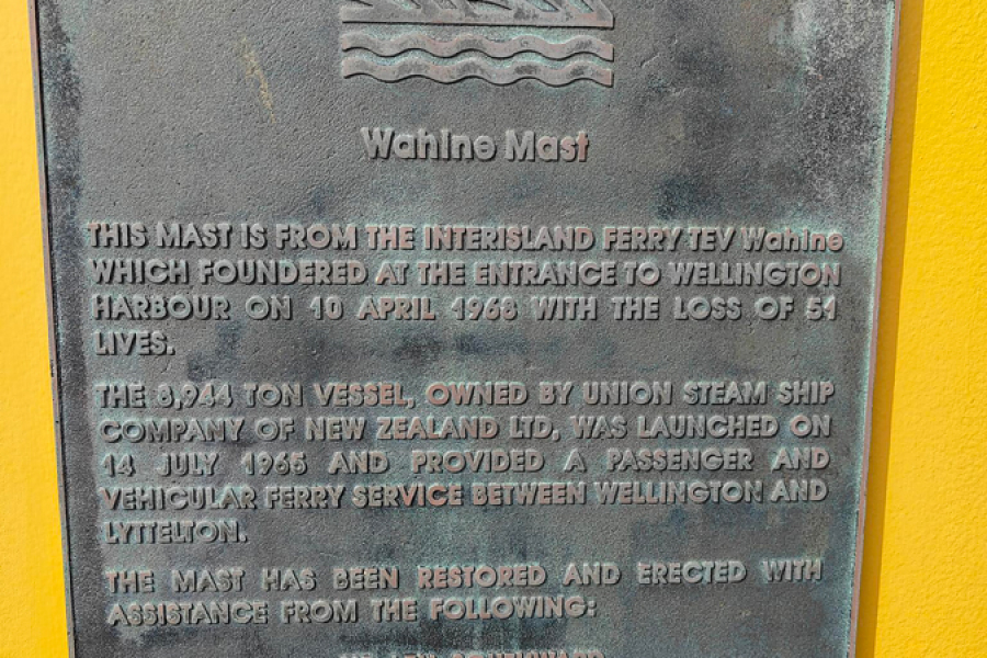Commemorative plaque attached to yellow wall