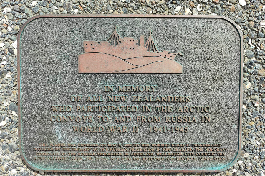 Commemorative plaque with image of a ship and large waves attached to wall