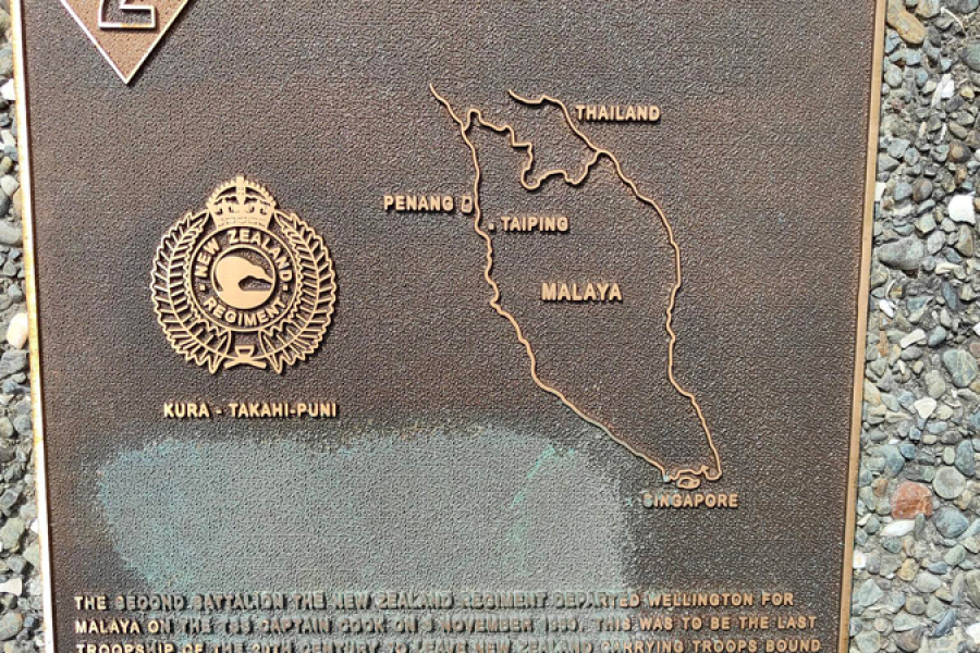 Commemorative plaque with 2 insignia and Second Battalion The New Zealand Regiment title attached to wall